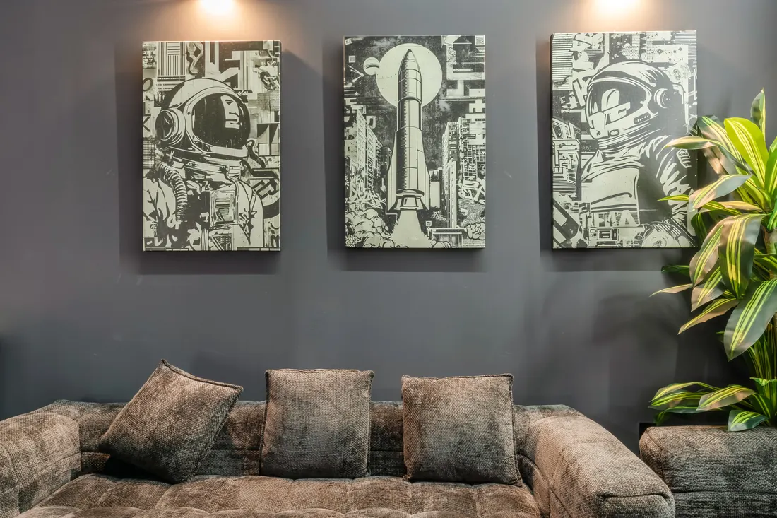 Lounge seating under three framed artworks at DG's Barber Shop