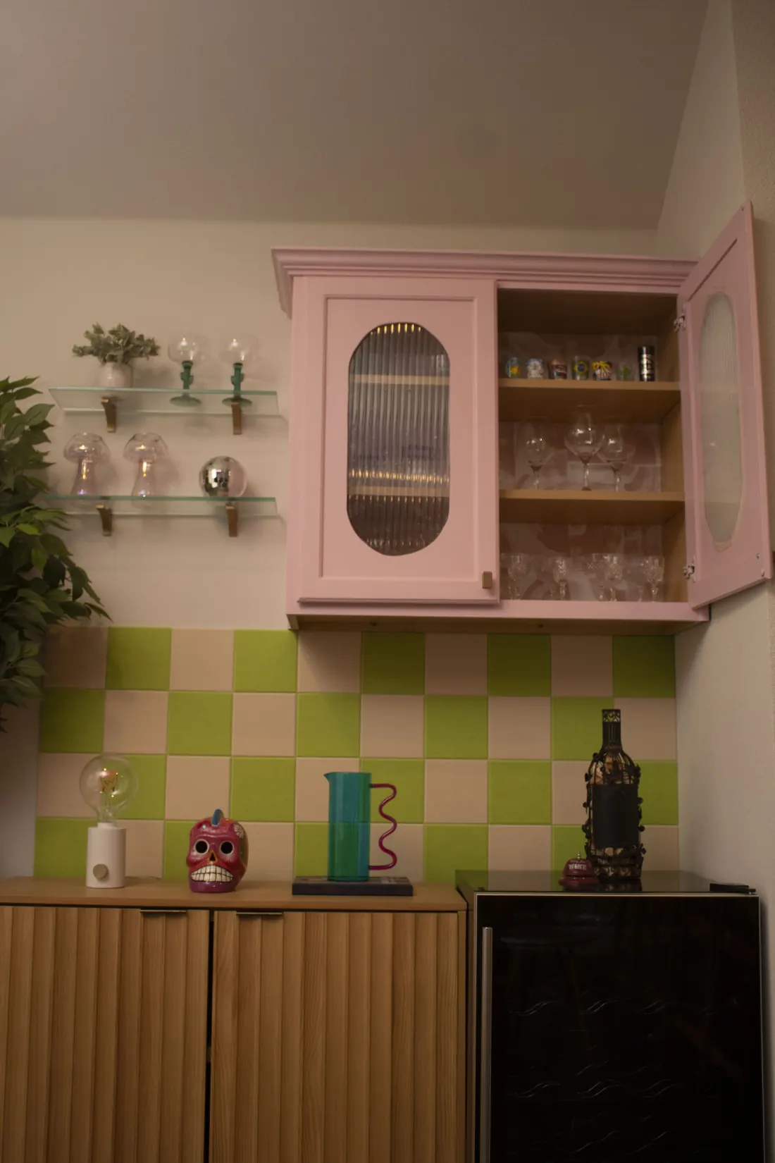 Pink cabinet bar nook with checkerboard backsplash
